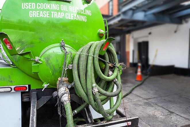 a grease trap pumping service in action at a commercial building in Copley