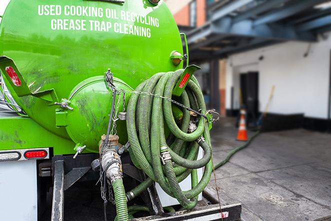 a technician pumping a grease trap in a commercial building in North Ridgeville OH